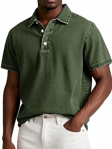 Detail view of a men's vintage green polo shirt with washed denim texture finish.