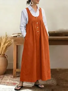Casual orange sleeveless button-front pinafore dress for women in a loose fit lifestyle view