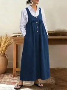 Casual navy blue button-up pinafore dress with a loose fit for a chic daily look.