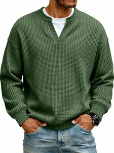 Close-up detail of men's dark green waffle knit sweater with a stylish notched V-neckline