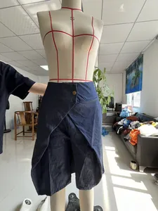 Detailed view of dark blue denim-look asymmetric culottes showcasing the unique waist design