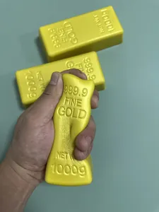 Detailed macro view of a gold brick shaped slow-rebound stress relief toy being squeezed