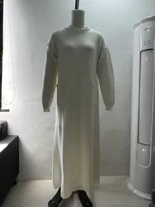 Full-length view of an off-white knitted high-neck maxi dress with pockets on mannequin.