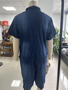 Detailed back view of a casual blue washed denim short-sleeve jumpsuit on a mannequin