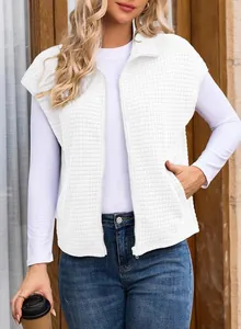 Close-up of white waffle-knit sleeveless vest with zipper and pockets for women