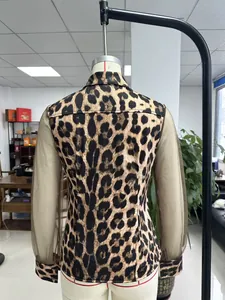 Elegant leopard print shirt with sheer brown mesh sleeves back view on mannequin