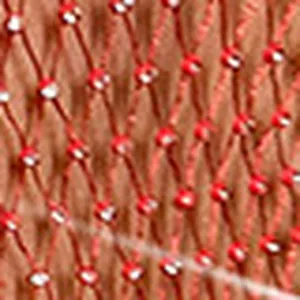 Detailed macro view of sparkling rhinestones on vibrant red fishnet mesh fabric garment