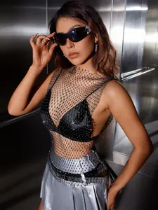Close-up of black mesh fishnet top featuring sparkling silver rhinestones on model