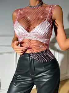 Close-up of pink fishnet mesh top with sparkling rhinestone embellishments and glitz.