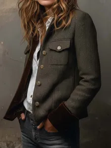 Close-up of vintage herringbone tweed blazer featuring elegant dark velvet cuffs