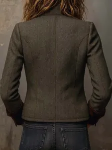 Detailed back view of a retro herringbone tweed blazer with brown velvet cuff trim