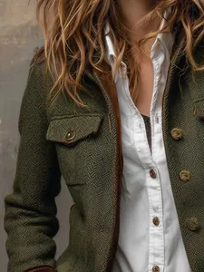 Detailed macro view showing the green herringbone tweed fabric and velvet trim