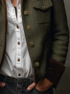 Close-up of retro herringbone tweed blazer with embossed buttons and velvet trim.