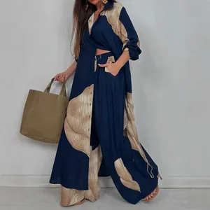 Elegante conjunto de dos piezas con camisa holgada y pantalones azul marino y beige.