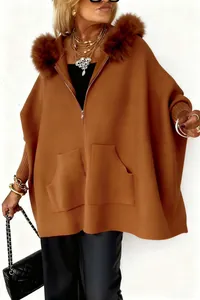 Detailansicht einer lockeren braunen Strickjacke mit großem Pelzkragen und Goldakzenten.