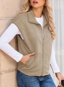 Detailed shot of women's khaki waffle-knit zip-up sleeveless oversized vest on model