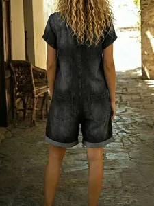 Back view of short sleeve washed denim romper shorts with multi-pockets and cuffed hem