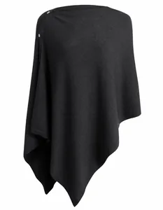 Close-up of black knitted multi-wear poncho with elegant shoulder button detail.