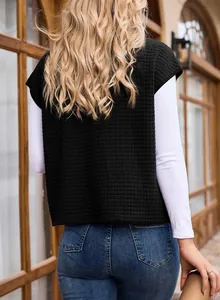Back view of black waffle sleeveless sweatshirt for women with white long sleeve top.