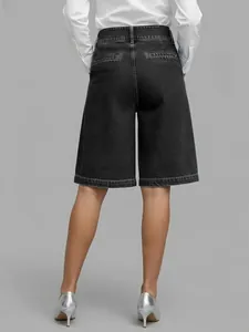 Detailed back view of women's black high-waisted denim culottes with welt pockets
