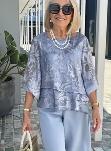 Elegant floral chiffon two-piece outfit featuring round neck top and blue trousers.