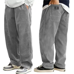 Detailed view of grey corduroy pants showing back pocket and ribbed fabric texture.