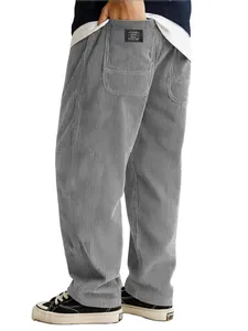 Detail view of men's gray corduroy pants featuring loose fit and pocket label texture