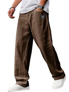 Detailweergave van de losse bruine heren vrijetijdsbroek met een logo op de zak.
