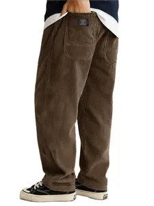 Macro detail view of men's loose brown corduroy trousers featuring back pocket patch