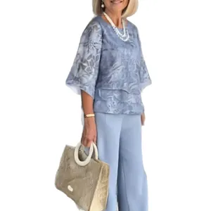 Elegant two-piece chiffon outfit featuring floral print top and light blue wide-leg pants.