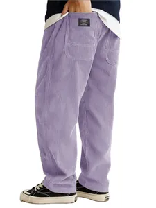 Detail view of purple corduroy men's loose pants with a classic style pocket label