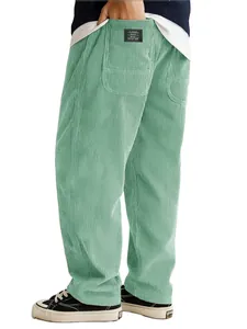 Close-up back view of men's loose green corduroy pants showing textured fabric and pocket label