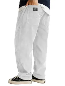 Detail of the corduroy texture and back pocket label on white relaxed pants