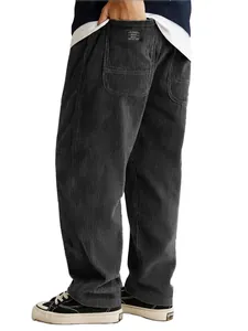 Detail view of men's loose corduroy trousers showing fabric texture and back pocket label.