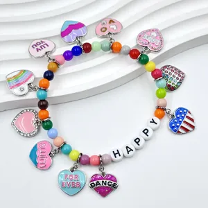 Macro detail of a colorful heart charm bracelet featuring HAPPY and DANCE letter beads.