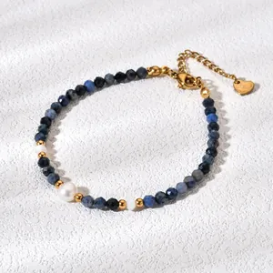 Macro detail of natural blue stone beads and pearls on a gold-plated bracelet