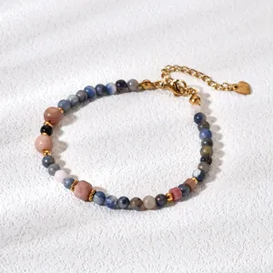 Detailed macro view of natural stone beaded bracelet with golden adjustable chain