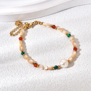 Detailed view of elegant gold-plated bracelet with shell beads and a large central pearl.