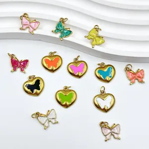 Detailed view of colorful enamel butterfly and heart-shaped pendants for jewelry DIY