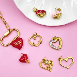 Close-up detail of stainless steel enamel heart charms with rhinestones and rose designs