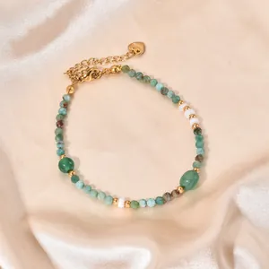 Close-up of a handmade natural green stone beaded bracelet on elegant satin background