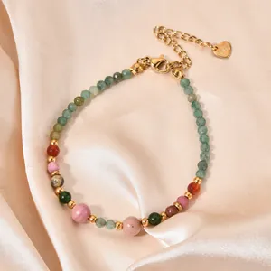 Close-up of a colorful natural stone bead bracelet with gold-plated heart charm