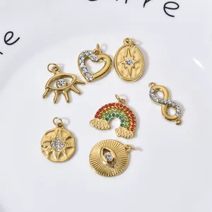 Assorted gold stainless steel jewelry charms featuring star, heart, eye, and rainbow designs