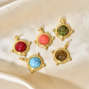 Group of five colorful natural stone pendants with 18K gold plating on satin fabric.