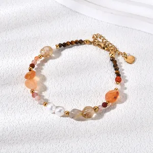 Detailed view of natural goldstone beaded bracelet with pearls and gold heart charm