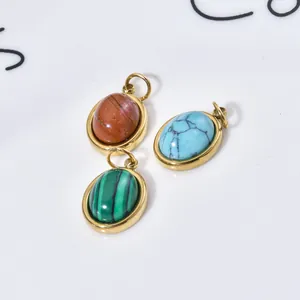 Close-up of stainless steel oval pendants featuring natural malachite and turquoise stones