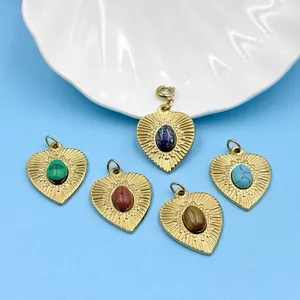 Detail of gold-plated heart pendants with oval semi-precious stones for DIY jewelry
