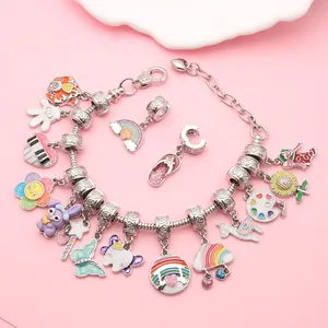 Close-up of DIY charm bracelet with colorful enamel heart and rainbow pendants