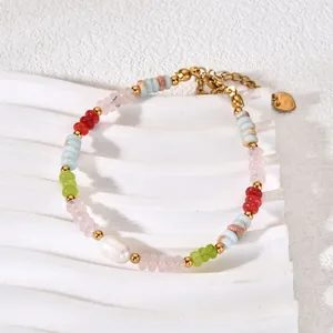 Close-up detail of a colorful natural stone gradient bracelet with a white pearl.