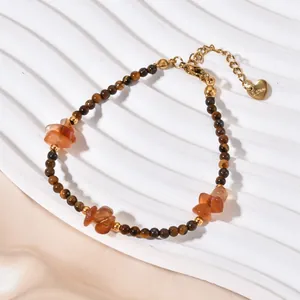 Close-up of vintage tiger eye and agate beaded bracelet with heart charm.